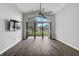 Large living room with wood floors, ceiling fan, and sliding glass doors leading to the outdoors at 4360 85Th Avenue E Cir, Parrish, FL 34219