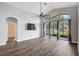 Bright living room features wood floors, ceiling fan, and sliding glass doors to the lanai at 4360 85Th Avenue E Cir, Parrish, FL 34219