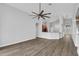 Open-concept living room with wood floors and bar seating to the kitchen for easy entertaining at 4360 85Th Avenue E Cir, Parrish, FL 34219