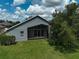 The rear exterior features a unique sunroom addition with expansive windows and a well-kept lawn at 4360 85Th Avenue E Cir, Parrish, FL 34219