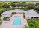 Aerial view of community pool, spa, and lounge area surrounded by lush greenery at 4460 Fairways Blvd # 607, Bradenton, FL 34209