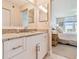 Bathroom with granite vanity and mirror, with partial view of Primary bedroom at 4460 Fairways Blvd # 607, Bradenton, FL 34209