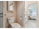 Bathroom with a toilet and partial view of vanity and bedroom at 4460 Fairways Blvd # 607, Bradenton, FL 34209