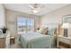 Comfortable bedroom with a ceiling fan, large window, and neutral decor at 4460 Fairways Blvd # 607, Bradenton, FL 34209