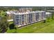 Aerial view showing the building's exterior with balconies and the surrounding green landscape at 4460 Fairways Blvd # 607, Bradenton, FL 34209