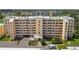 Multi-story condo building with parking and beautiful landscaping on a sunny day at 4460 Fairways Blvd # 607, Bradenton, FL 34209