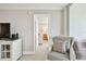 Cozy hallway showcases neutral tones, an inviting armchair, and a glimpse into the serene bedroom at 4460 Fairways Blvd # 607, Bradenton, FL 34209