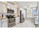 Well-appointed kitchen with stainless steel appliances and a dining area with window views at 4460 Fairways Blvd # 607, Bradenton, FL 34209