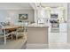 Bright, open kitchen featuring granite countertops, white cabinets, and stainless steel appliances at 4460 Fairways Blvd # 607, Bradenton, FL 34209