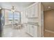 Eat-in kitchen area with white cabinetry, granite counters, and a bright window view at 4460 Fairways Blvd # 607, Bradenton, FL 34209