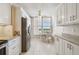 Efficient kitchen design featuring stainless steel appliances, white cabinets, and granite countertops at 4460 Fairways Blvd # 607, Bradenton, FL 34209