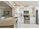Modern kitchen with stainless steel appliances, white cabinets, and granite countertops at 4460 Fairways Blvd # 607, Bradenton, FL 34209