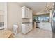 Bright kitchen featuring white cabinetry, granite countertops, and stainless steel appliances at 4460 Fairways Blvd # 607, Bradenton, FL 34209
