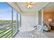 Screened lanai showcasing seating, with views of the green golf course and the residence's cozy interior at 4460 Fairways Blvd # 607, Bradenton, FL 34209