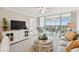 Open living space with a TV, comfortable seating, and access to the balcony at 4460 Fairways Blvd # 607, Bradenton, FL 34209