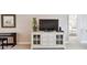 Living room console with a TV and decor, positioned beside a doorway and piano at 4460 Fairways Blvd # 607, Bradenton, FL 34209