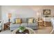 Close-up showcases a striped sofa with decorative pillows, complemented by matching lamps and a white rattan coffee table at 4460 Fairways Blvd # 607, Bradenton, FL 34209