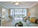 Spacious living room featuring a ceiling fan, balcony access, and comfortable furniture at 4460 Fairways Blvd # 607, Bradenton, FL 34209