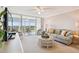 Bright living room with comfortable seating, a glass table, and a view of the balcony at 4460 Fairways Blvd # 607, Bradenton, FL 34209