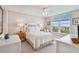 Comfortable main bedroom with white furnishings, a large window overlooking trees, and ample natural light at 4460 Fairways Blvd # 607, Bradenton, FL 34209