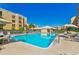 Sparkling community pool surrounded by lounge chairs and well-maintained landscaping at 4460 Fairways Blvd # 607, Bradenton, FL 34209