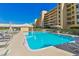 Inviting community pool area with lounge chairs and manicured landscaping, perfect for relaxation at 4460 Fairways Blvd # 607, Bradenton, FL 34209