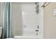 Clean white shower with white subway tile and handy storage caddy at 4460 Fairways Blvd # 607, Bradenton, FL 34209