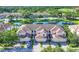 Beautiful aerial view of the townhouse community with lake views, golf course, and lush green landscaping at 4487 Cinnamon Dr # 2604, Sarasota, FL 34238