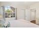 Inviting bedroom featuring a decorative arched window and ample closet space at 4487 Cinnamon Dr # 2604, Sarasota, FL 34238