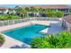 Inviting community pool surrounded by palm trees and lush landscaping at 4487 Cinnamon Dr # 2604, Sarasota, FL 34238