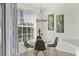 Cozy dining area featuring a glass table, contemporary chandelier and colorful tropical artwork at 4487 Cinnamon Dr # 2604, Sarasota, FL 34238