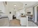 Bright kitchen features white cabinets, stainless steel sink, and a breakfast bar open to the living area at 4487 Cinnamon Dr # 2604, Sarasota, FL 34238