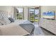 Serene main bedroom with a view of the lake, and a sliding glass door to the lanai at 4487 Cinnamon Dr # 2604, Sarasota, FL 34238