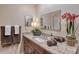 Bathroom vanity with marble countertop, decor, large mirror, towels and flowers at 4555 Chandlers Forde # 47, Sarasota, FL 34235