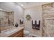 Well-lit bathroom featuring a vanity with a marble countertop and a decorative mirror at 4555 Chandlers Forde # 47, Sarasota, FL 34235