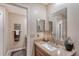 Bathroom vanity featuring marble countertop, large mirror and modern decor at 4555 Chandlers Forde # 47, Sarasota, FL 34235