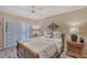 Bedroom featuring a ceiling fan, wooden furniture, shutter doors, and neutral walls at 4555 Chandlers Forde # 47, Sarasota, FL 34235