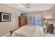 Cozy bedroom features shutter doors, ceiling fan, and dark wooden furniture at 4555 Chandlers Forde # 47, Sarasota, FL 34235
