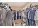 Walk-in closet with rods and shelves full of neatly organized clothing and folded items at 4555 Chandlers Forde # 47, Sarasota, FL 34235