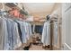 Walk-in closet with shelves and rods full of clothes, bags and shoes at 4555 Chandlers Forde # 47, Sarasota, FL 34235