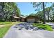 Charming single-story home with attached garage and a long driveway, surrounded by lush greenery at 4555 Chandlers Forde # 47, Sarasota, FL 34235