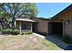 Inviting front entrance with covered porch and manicured landscaping, offering curb appeal at 4555 Chandlers Forde # 47, Sarasota, FL 34235