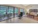 Bright living room boasts a tile floor, outdoor view and comfortable chairs at 4555 Chandlers Forde # 47, Sarasota, FL 34235
