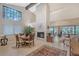 Bright living room boasts a fireplace, tall windows and sliding doors with views of outdoor at 4555 Chandlers Forde # 47, Sarasota, FL 34235