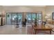 Bright living room boasts a tile floor, outdoor view and comfortable chairs at 4555 Chandlers Forde # 47, Sarasota, FL 34235