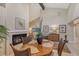 Bright living room boasts a fireplace, tall windows and view to breakfast nook at 4555 Chandlers Forde # 47, Sarasota, FL 34235