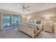 Inviting main bedroom with a patio access, a ceiling fan, and soft neutral tones for rest and relaxation at 4555 Chandlers Forde # 47, Sarasota, FL 34235