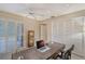 Well-lit home office with desk, louvred closet doors, and a ceiling fan at 4555 Chandlers Forde # 47, Sarasota, FL 34235