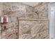 Shower features marble tile, glass shelving, and a shower head on a hose at 4555 Chandlers Forde # 47, Sarasota, FL 34235