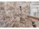 Close up view of tiled shower with shower head on hose and hand rail at 4555 Chandlers Forde # 47, Sarasota, FL 34235